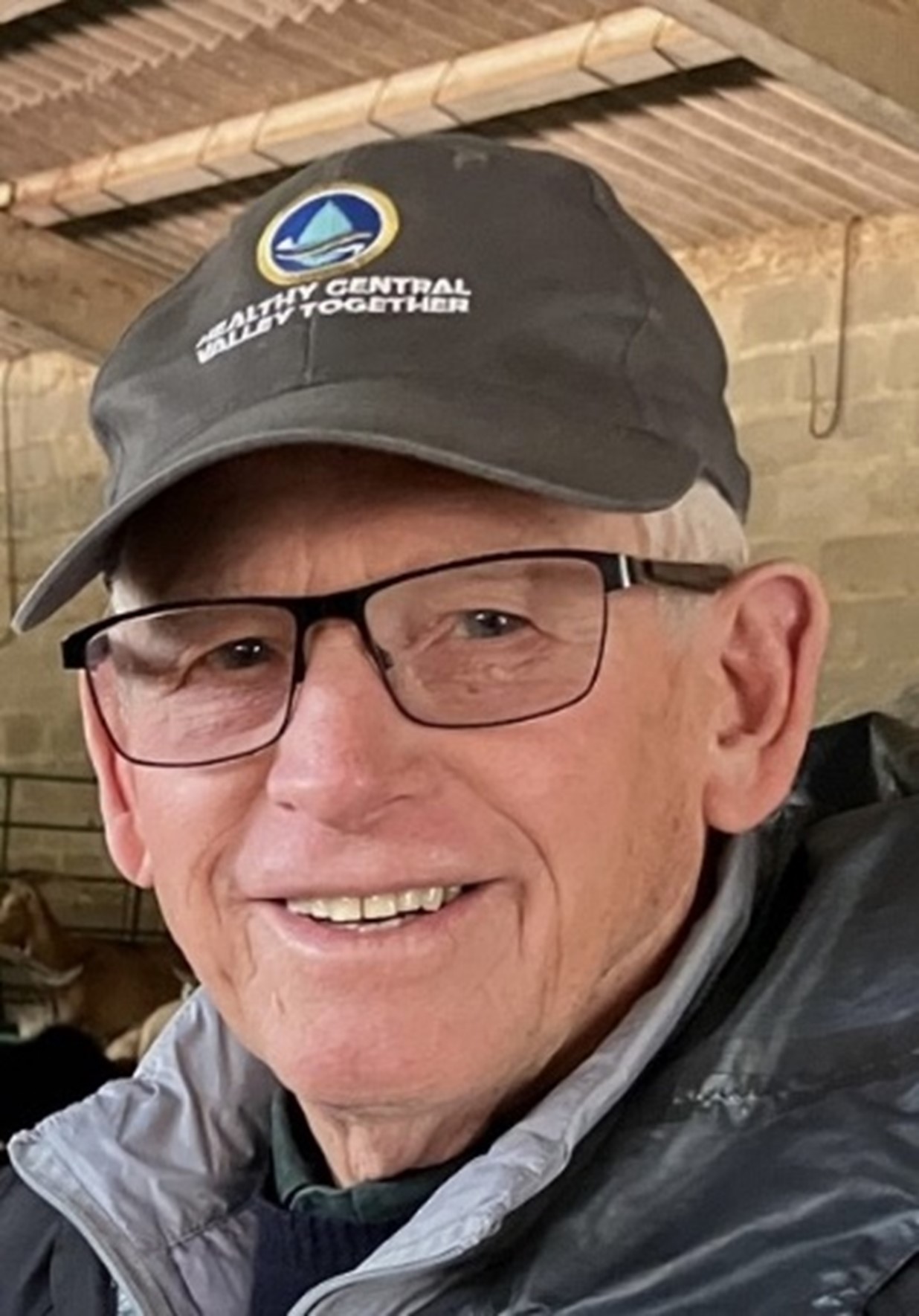 Tom wearing a baseball cap and glasses.