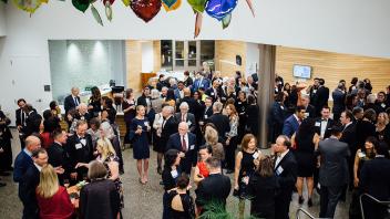 Crowd of attendees standing in lobby of Betty Irene Moore Hall