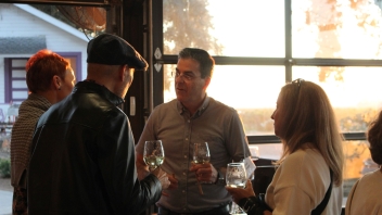 Man Talking to Two Other People 