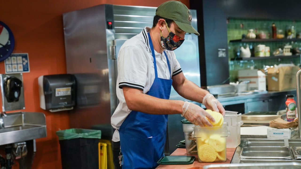 student standing over food at the Coffee House