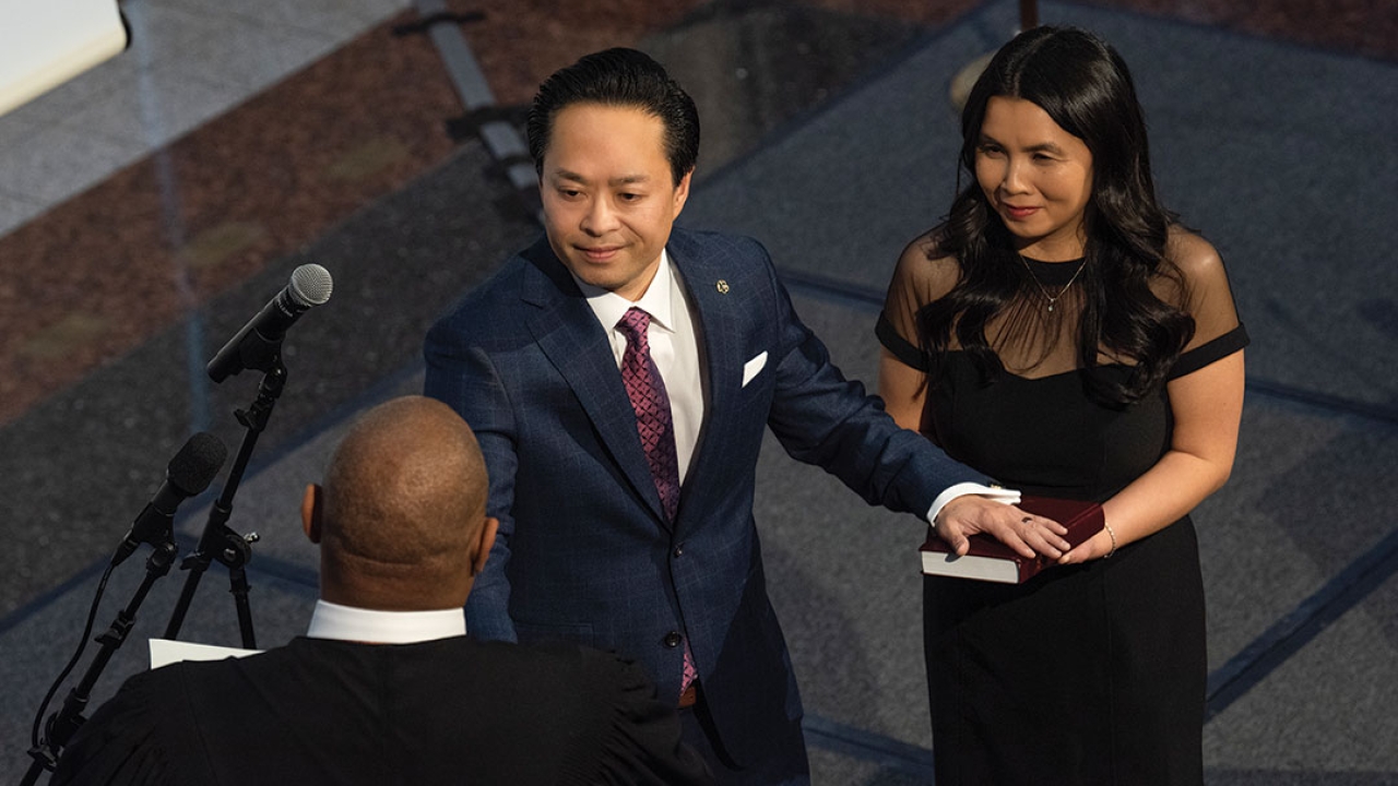 Thien Ho takes his oath of office standing beside his wife, Jenny, whom he met as an undergraduate at UC Davis.