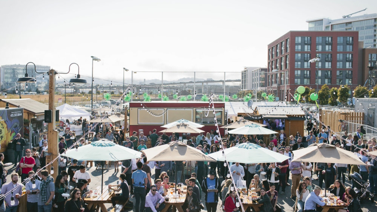Image of people gathered at SPARK Social SF, an outdoor food truck park and gathering space