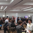 crowd of people at talking to representatives at company tables
