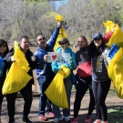 Picture of six people standing along the Potomac holding up trash bags and a sign saying "I <3 Clean Water".
