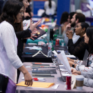 Photo of career fair attendees chatting with recruiters and employers